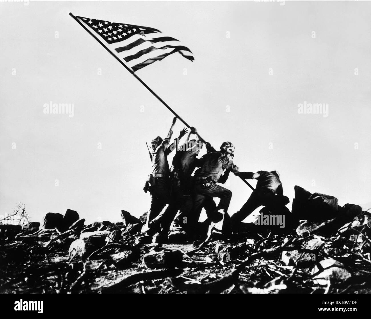 SCENE WITH TROOPS RAISING FLAG SANDS OF IWO JIMA (1949) Stock Photo