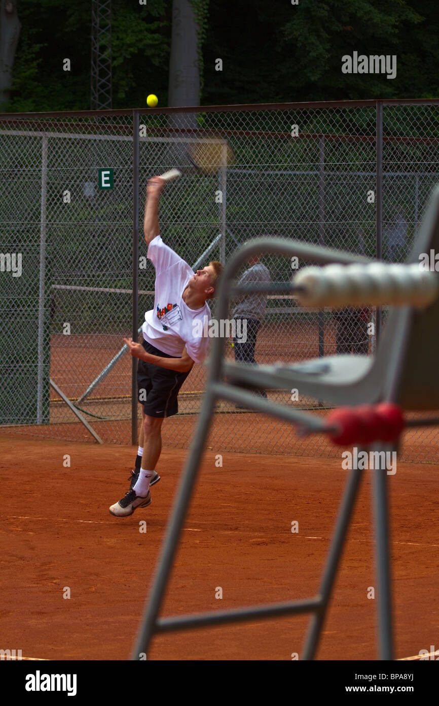 Tennis player serving. Seen through the referee chair. Portrait Stock Photo