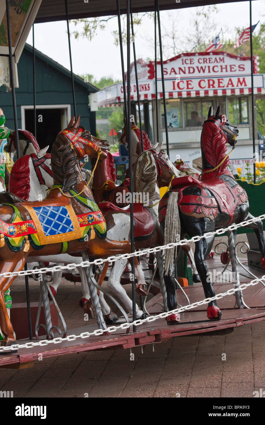 Tulip time festival Dutch Holland Michigan in USA  close up of a round historical carousel wooden colorful figures vertical from front nobody hi-res Stock Photo