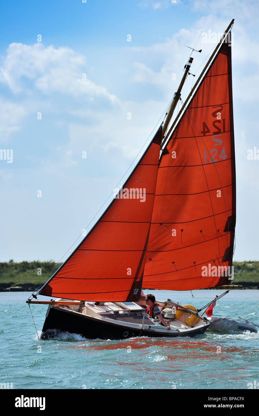 Red Sails - Sailing boat on the estuary Stock Photo