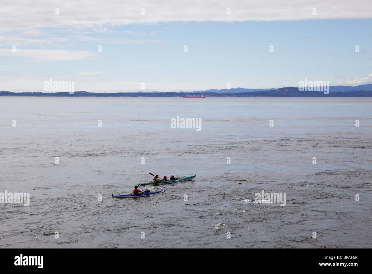 Sea kayaks. Lime Kiln State Park, Washington. San Juan Island. Note strong current. Vancouver Island in background. Stock Photo