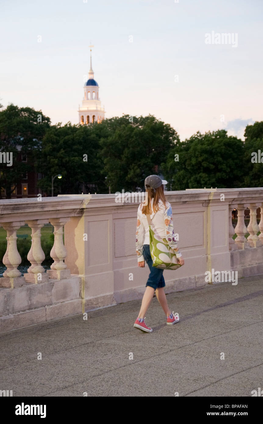 A female student walks across the John W. Weeks into Cambridge Massachusetts Stock Photo
