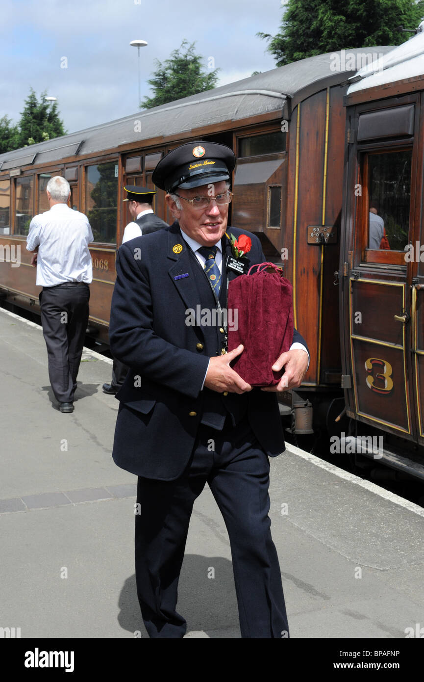 Severn Valley Railway Station Manager Geoff Smith carrying the ashes of deceased railway enthusiast to be put in the firebox . Stock Photo