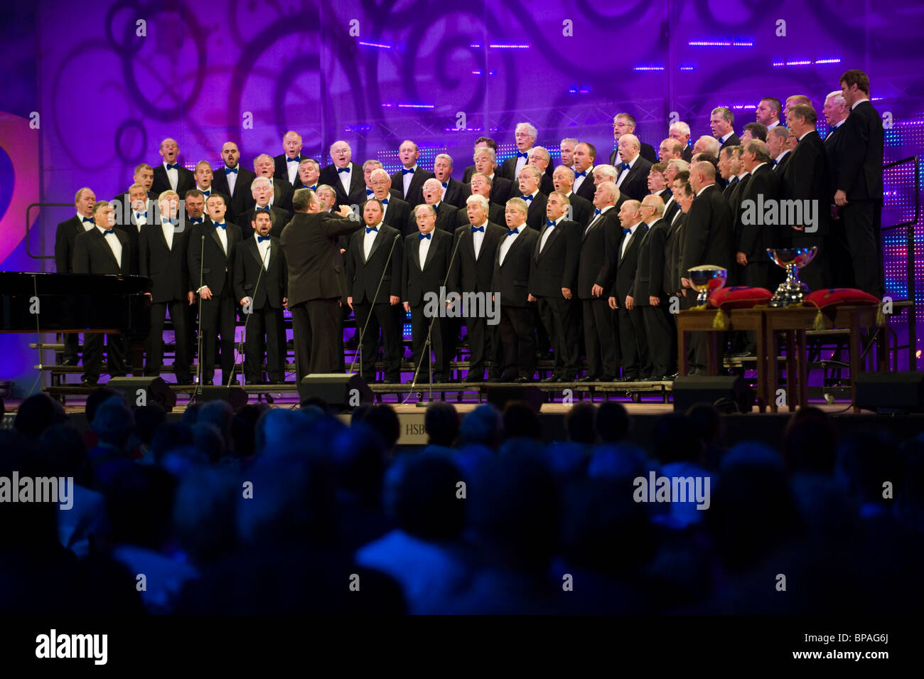 Male voice choir singing on stage in competition at the National Eisteddfod of Wales annual
