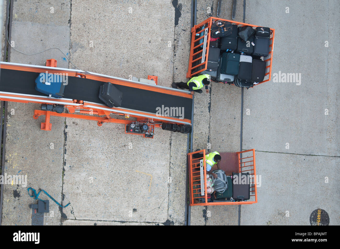 Suitcases being loaded onto a cruise ship by baggage handlers in