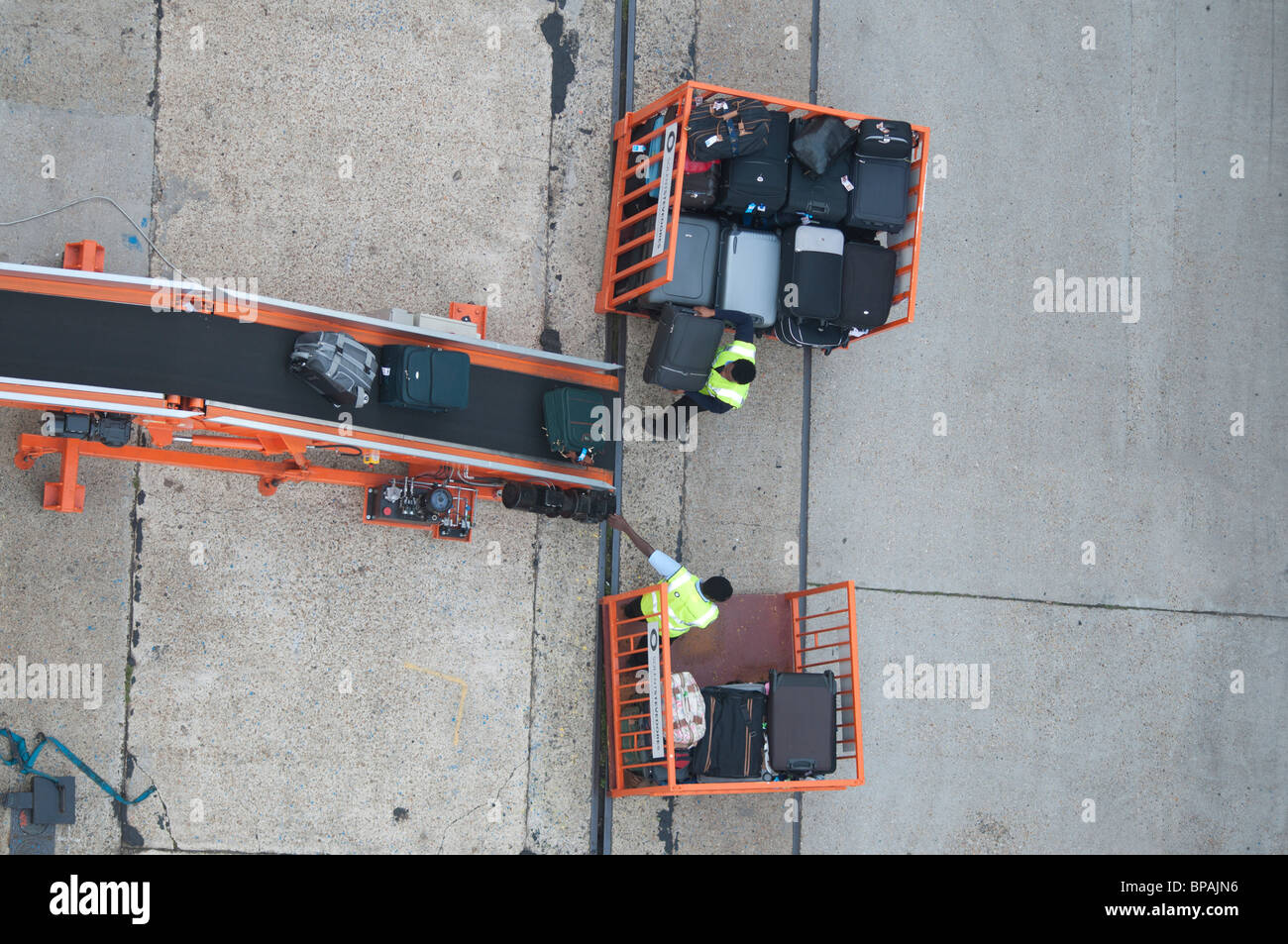 Suitcases being loaded onto a cruise ship by baggage handlers in Southampton, England. Stock Photo