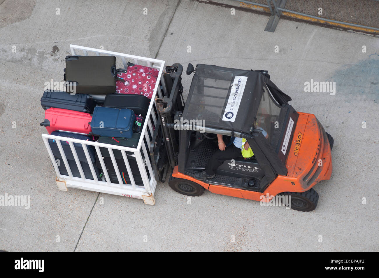 A fork lift truck transporting suitcases to a cruise ship in Southampton, England. Stock Photo