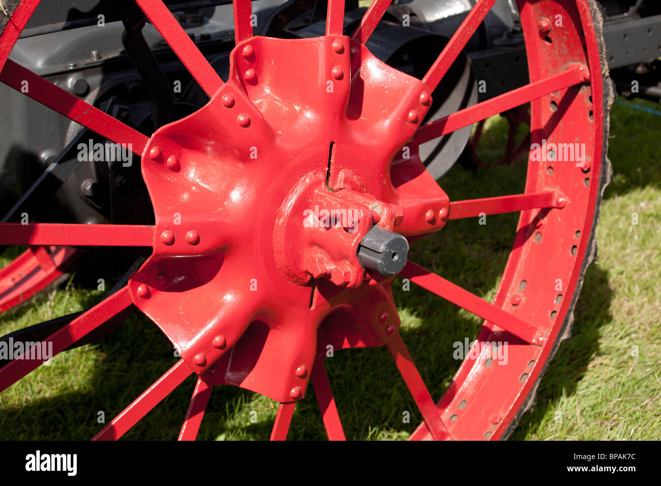 Red painted iron spokes on tractor wheel Stock Photo Alamy