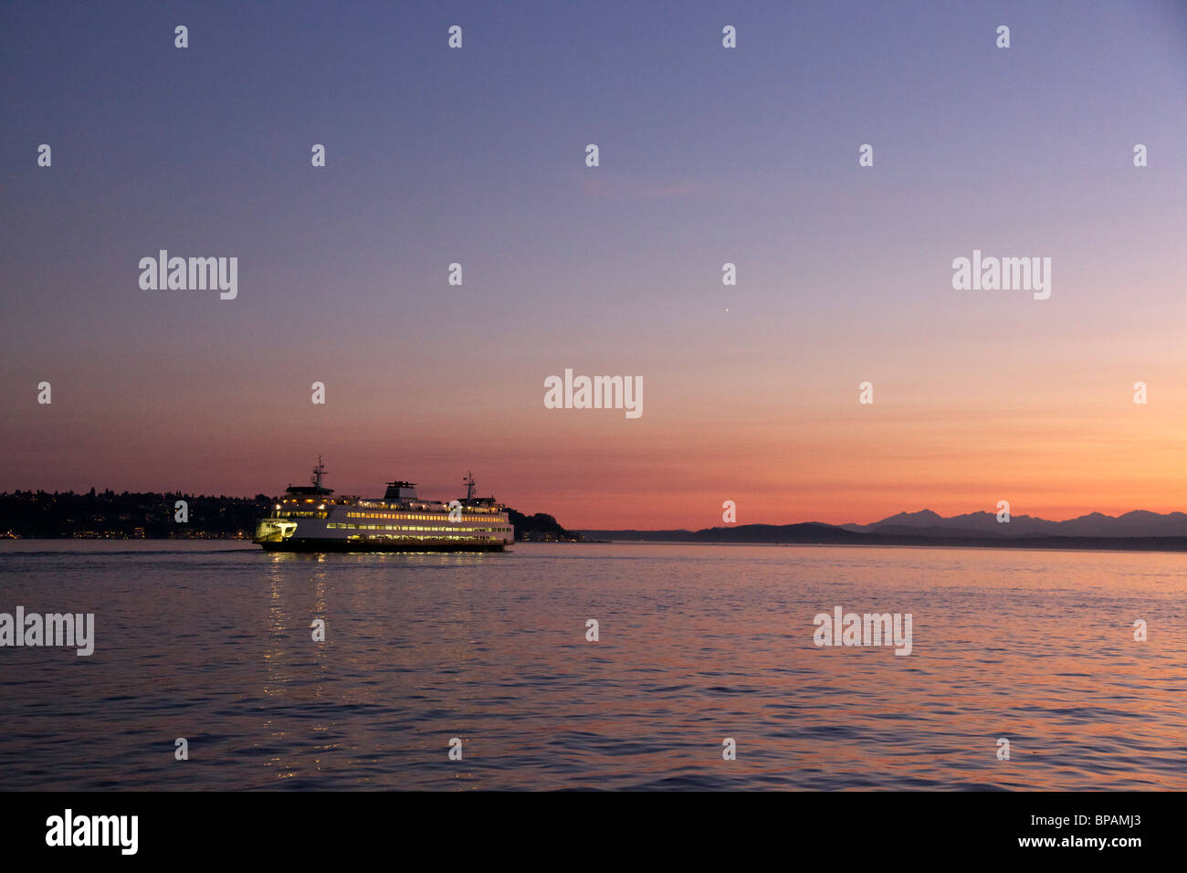 Washington State Ferry sailing from Seattle at twilight. Bright point