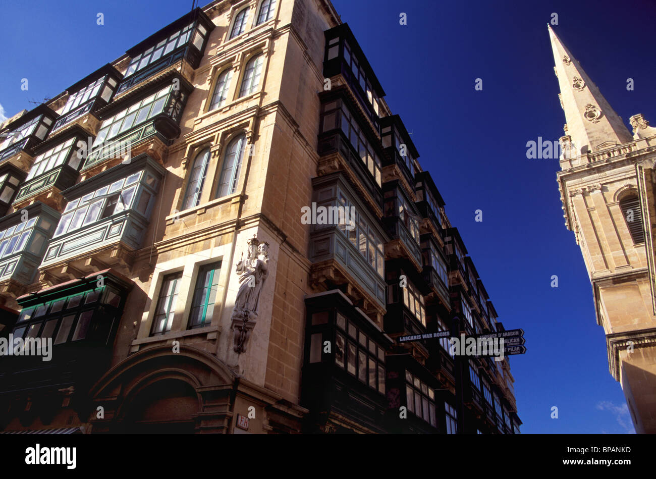 Enclosed balconies encrust many of Valletta's multi-story apartment blocks. Stock Photo