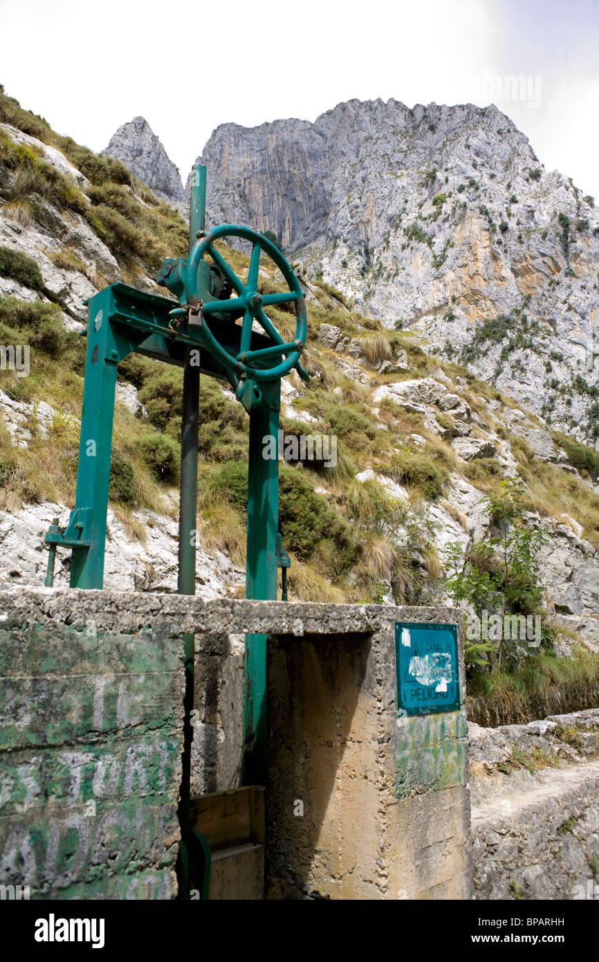 Sluice gate controlling water flow on the Hydro-electric system on the River Cares, Cares Gorge, Picos de Europa, Spain, Stock Photo