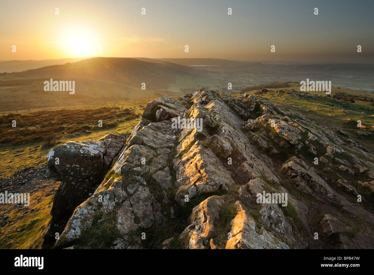 Sunrise atop Crook Peak, Somerset, on a warm spring morning. Stock Photo