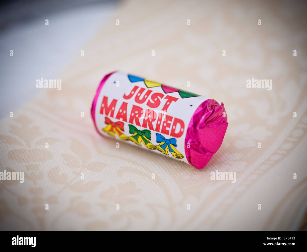 JUST MARRIED Love Hearts Sweets wedding favour on a napkin at wedding reception. Stock Photo