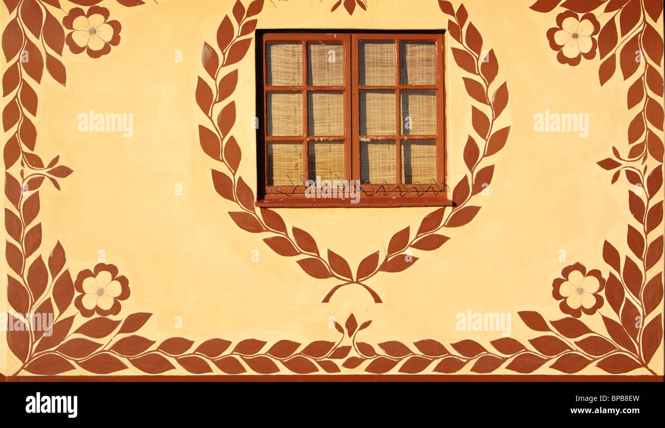 Wall of a hut decorated with traditional African motifs Stock Photo