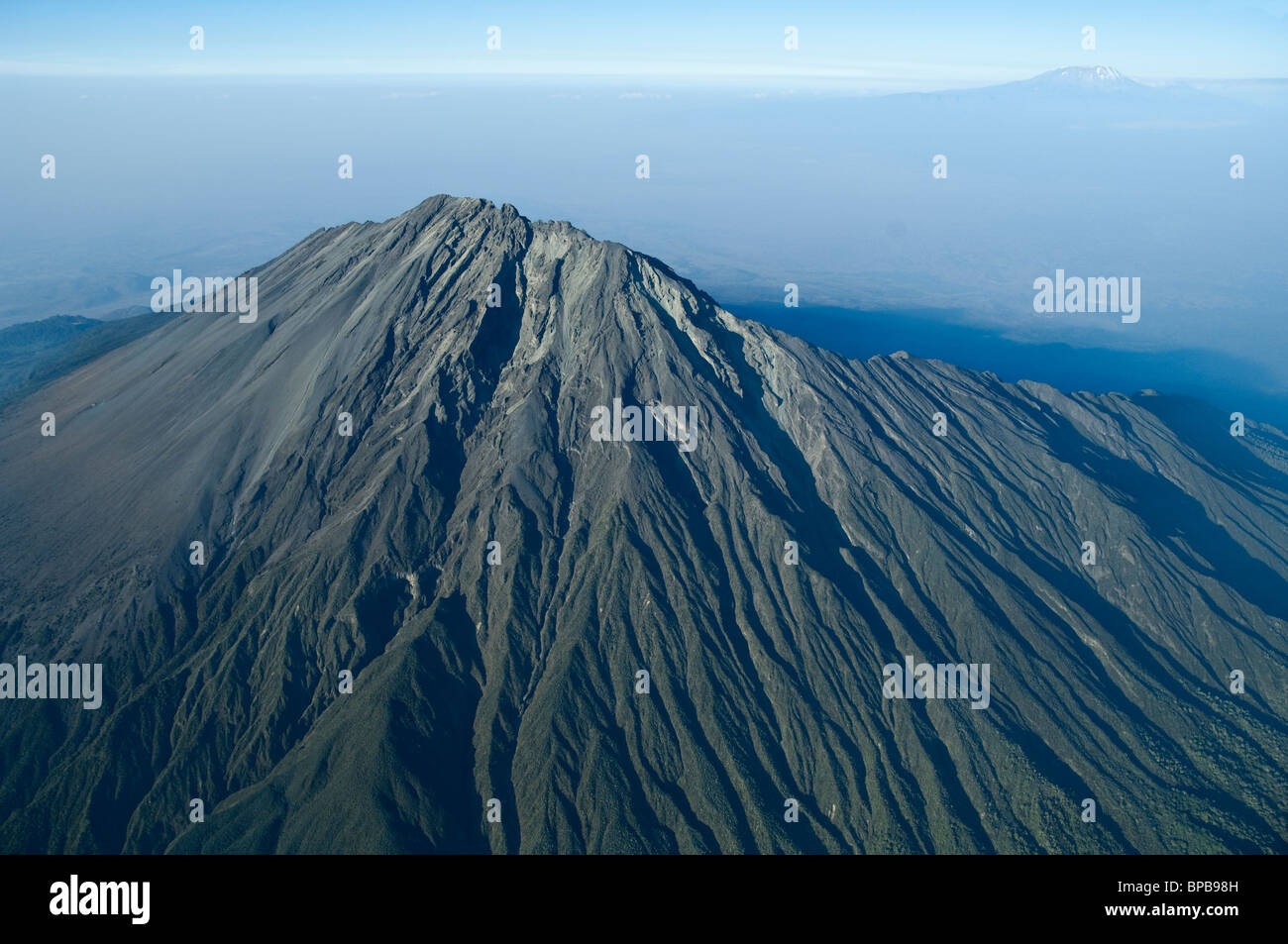 Aerial view of the volcano Mount Meru with Kilimanjari in the background Tanzania Stock Photo
