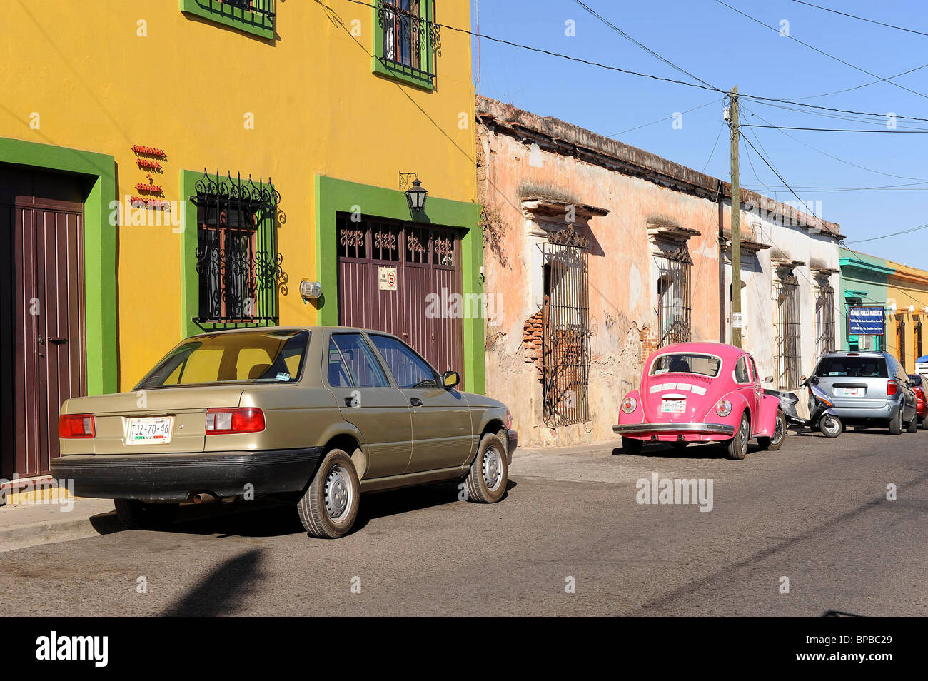 Homes and parked cars in residential street in Oaxaca, Mexico. Stock Photo