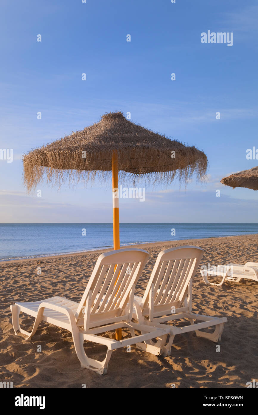 torremolinos, malaga, andalusia, spain; sun umbrellas and beach beds on