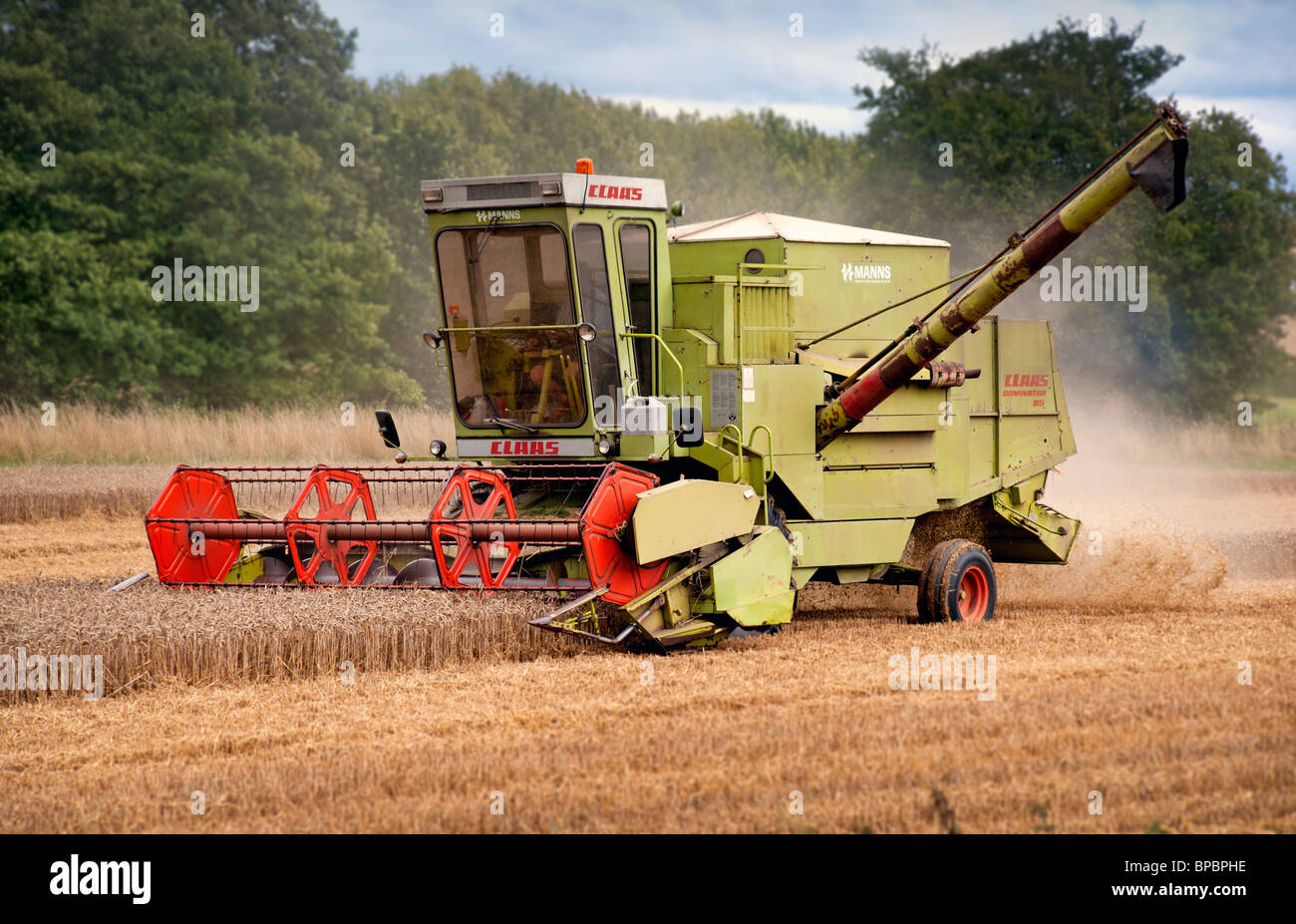 Combine Harvester harvesting wheat in East Anglia Stock Photo