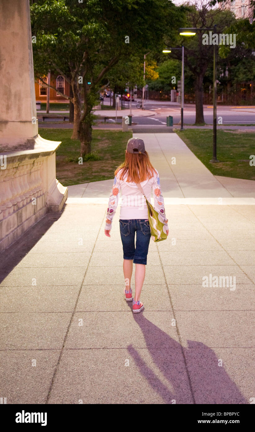 A female student walks across the John W. Weeks into Cambridge Massachusetts Stock Photo