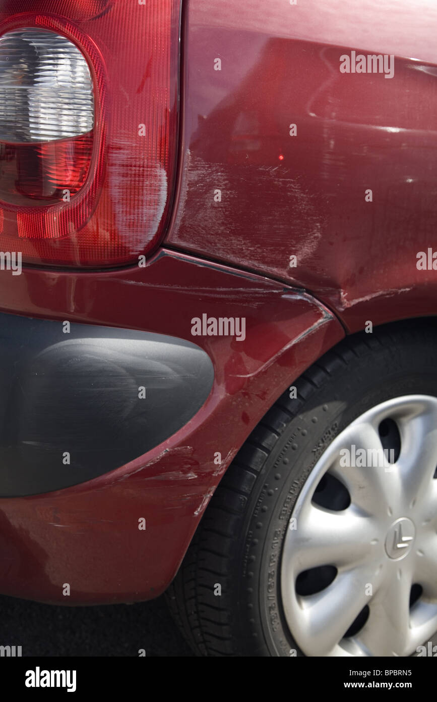 Damage on the corner on the back of a red car Stock Photo