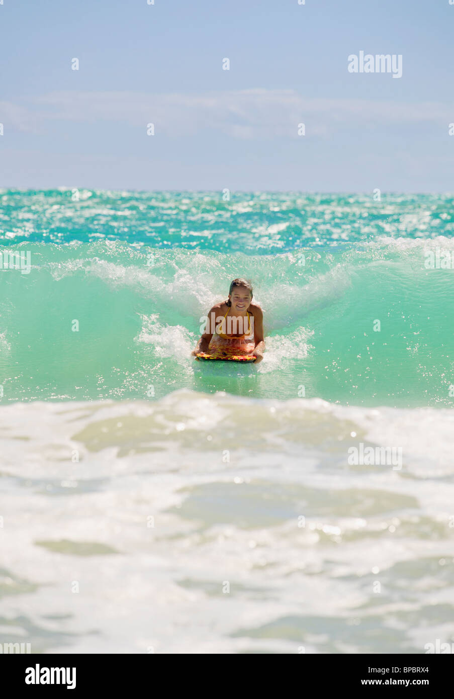 teenage girl boogie boarding the waves in Hawaii Stock Photo Alamy