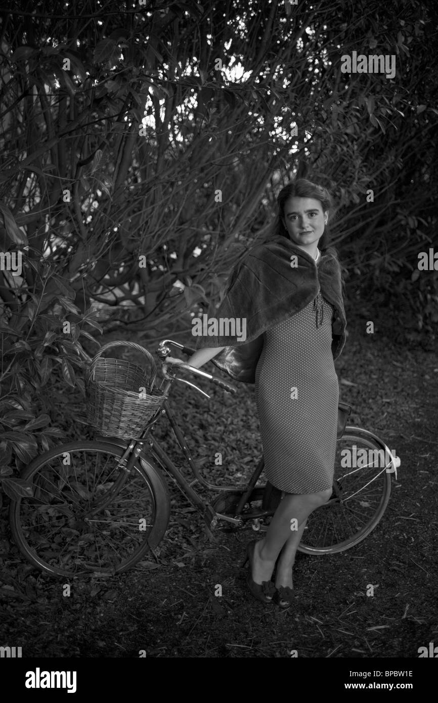 Girl with a bicycle in a vintage 1940 style Stock Photo
