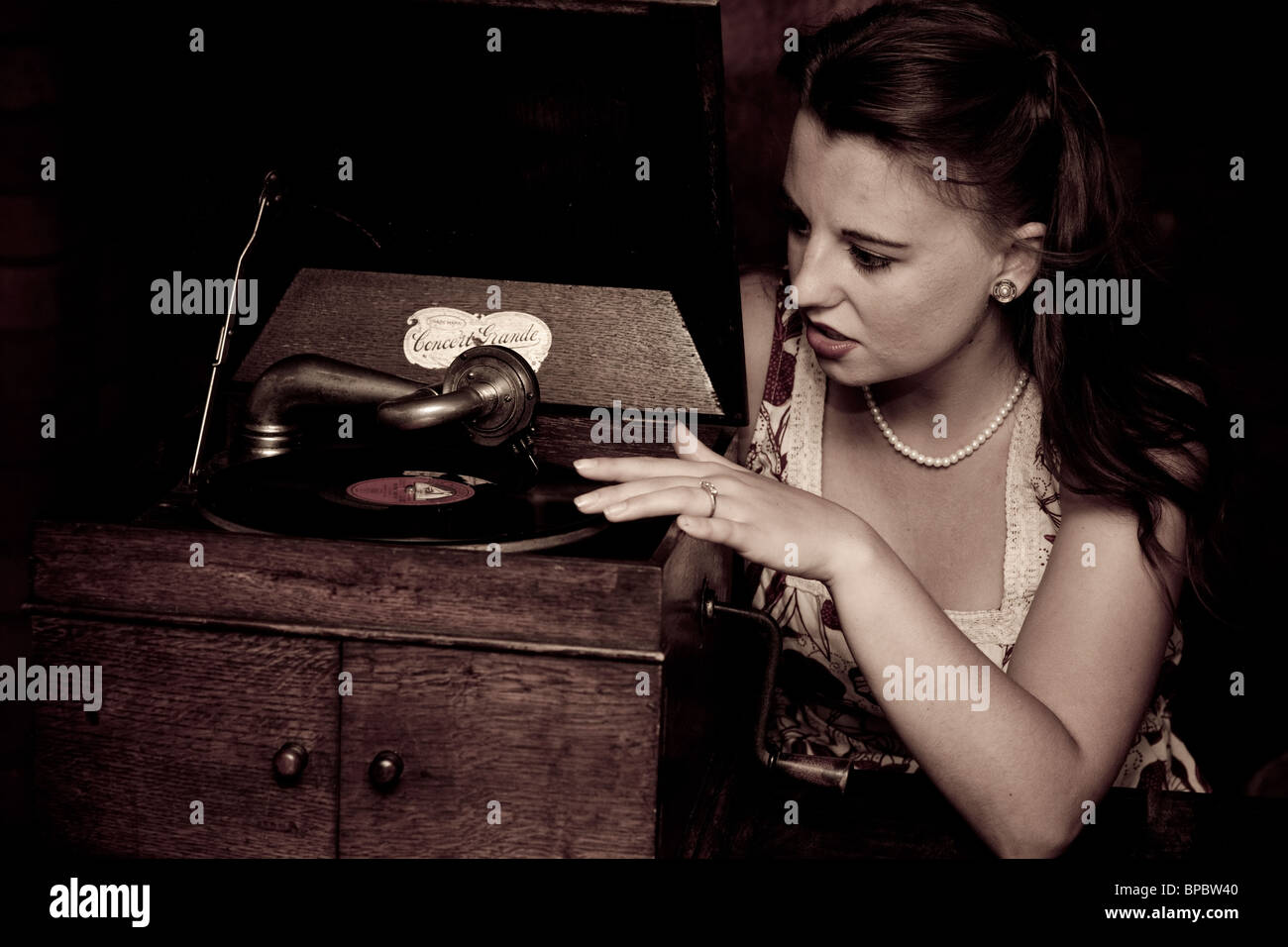 Woman with a gramophone player in a cottage shot in a vintage 1940 style Stock Photo