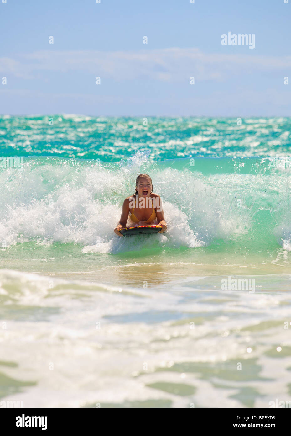teenage girl boogie boarding the waves in Hawaii Stock Photo Alamy