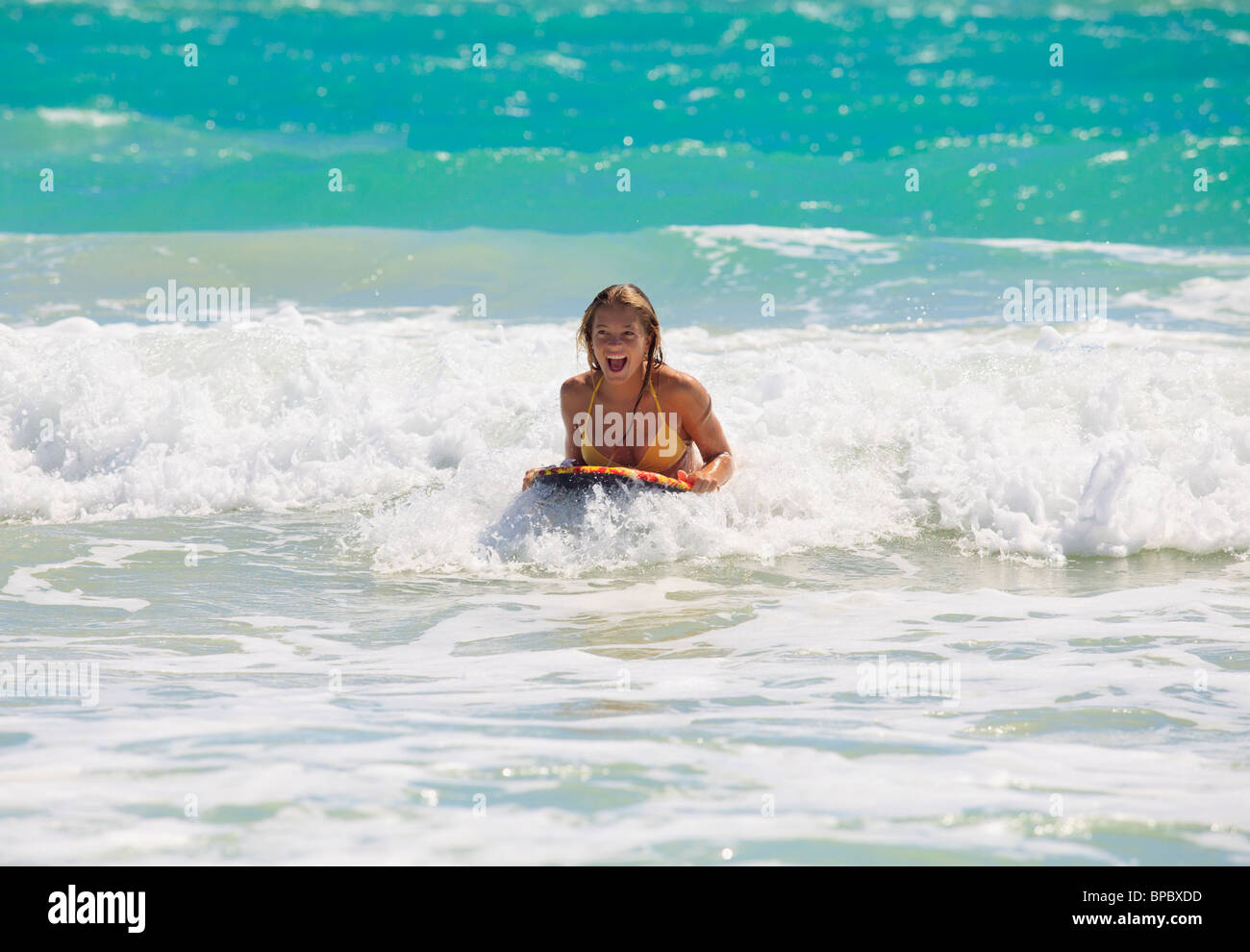 teenage girl boogie boarding the waves in Hawaii Stock Photo Alamy