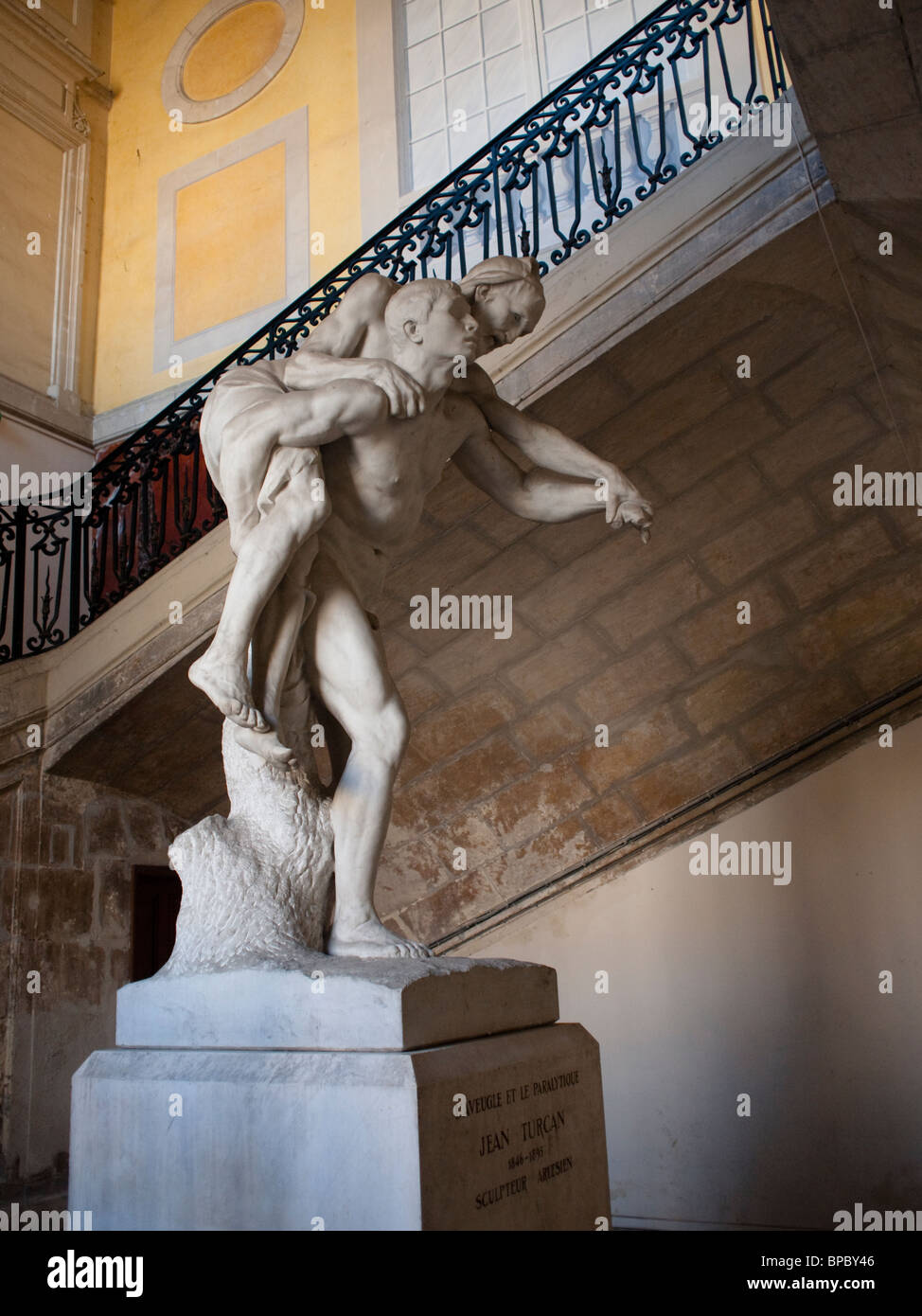 Classical Statue L'Aveugle et la Paralytique by Jean Turcan in St Trophime,  Arles, France Stock Photo - Alamy