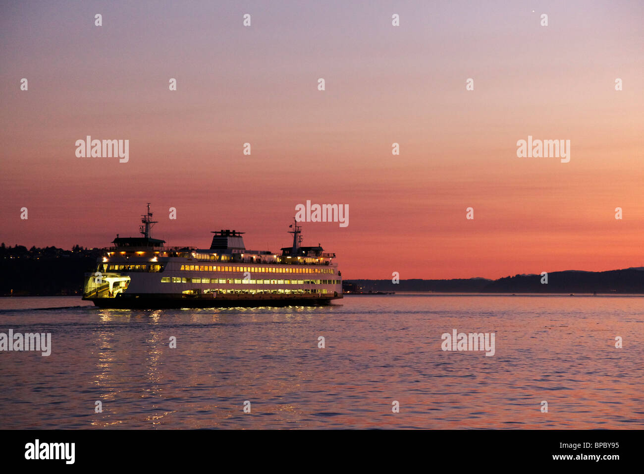 Washington State Ferry sailing from Seattle at twilight. Bright point
