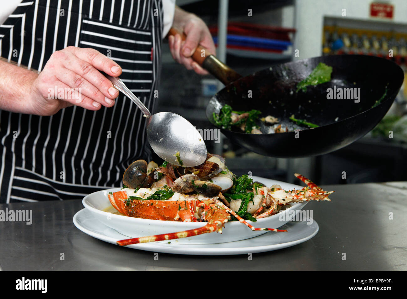 A chef preparing a seafood dish Stock Photo Alamy