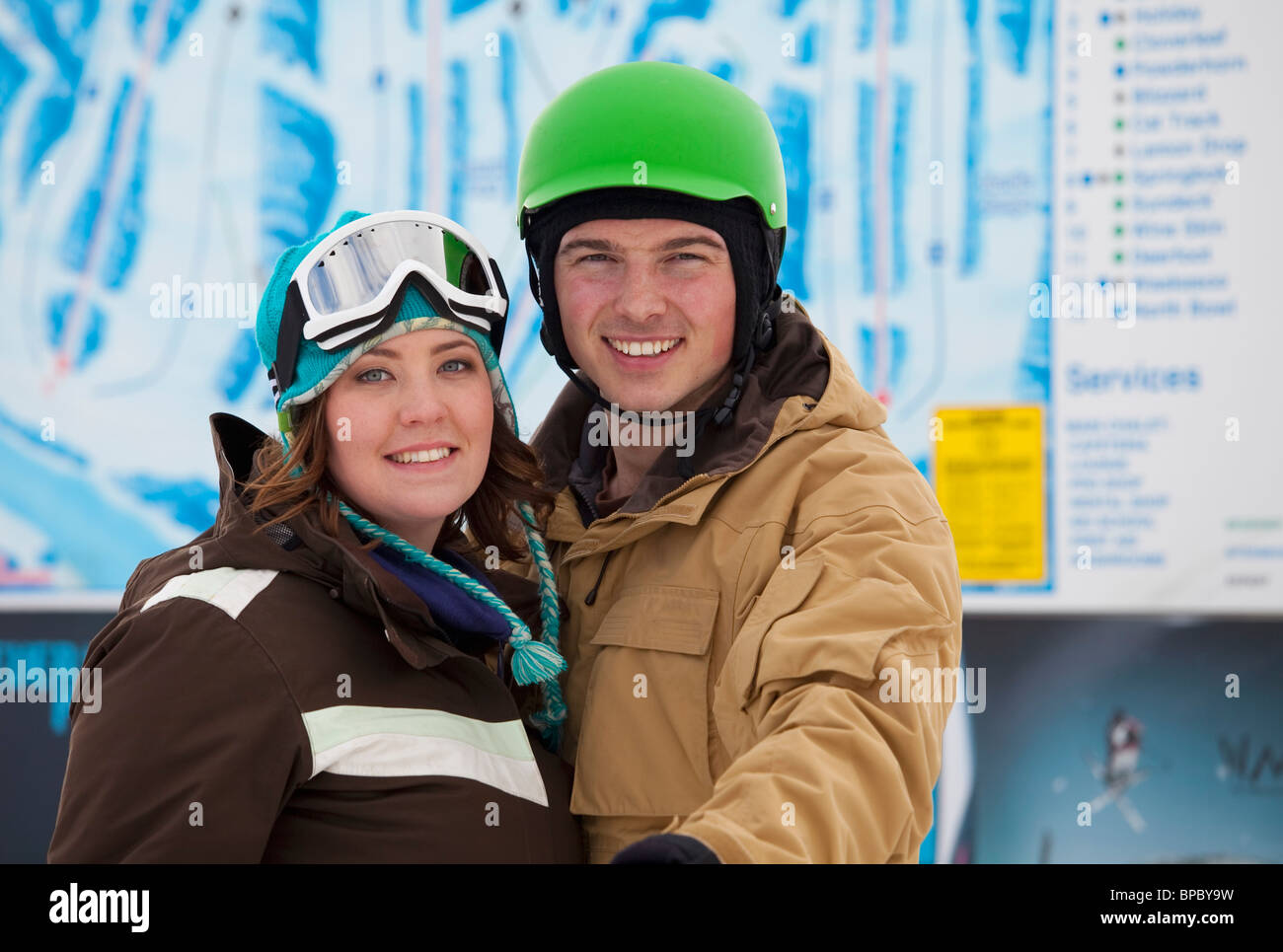 red deer, alberta, canada; a man and woman wearing a helmet and ski mask at a ski area Stock Photo