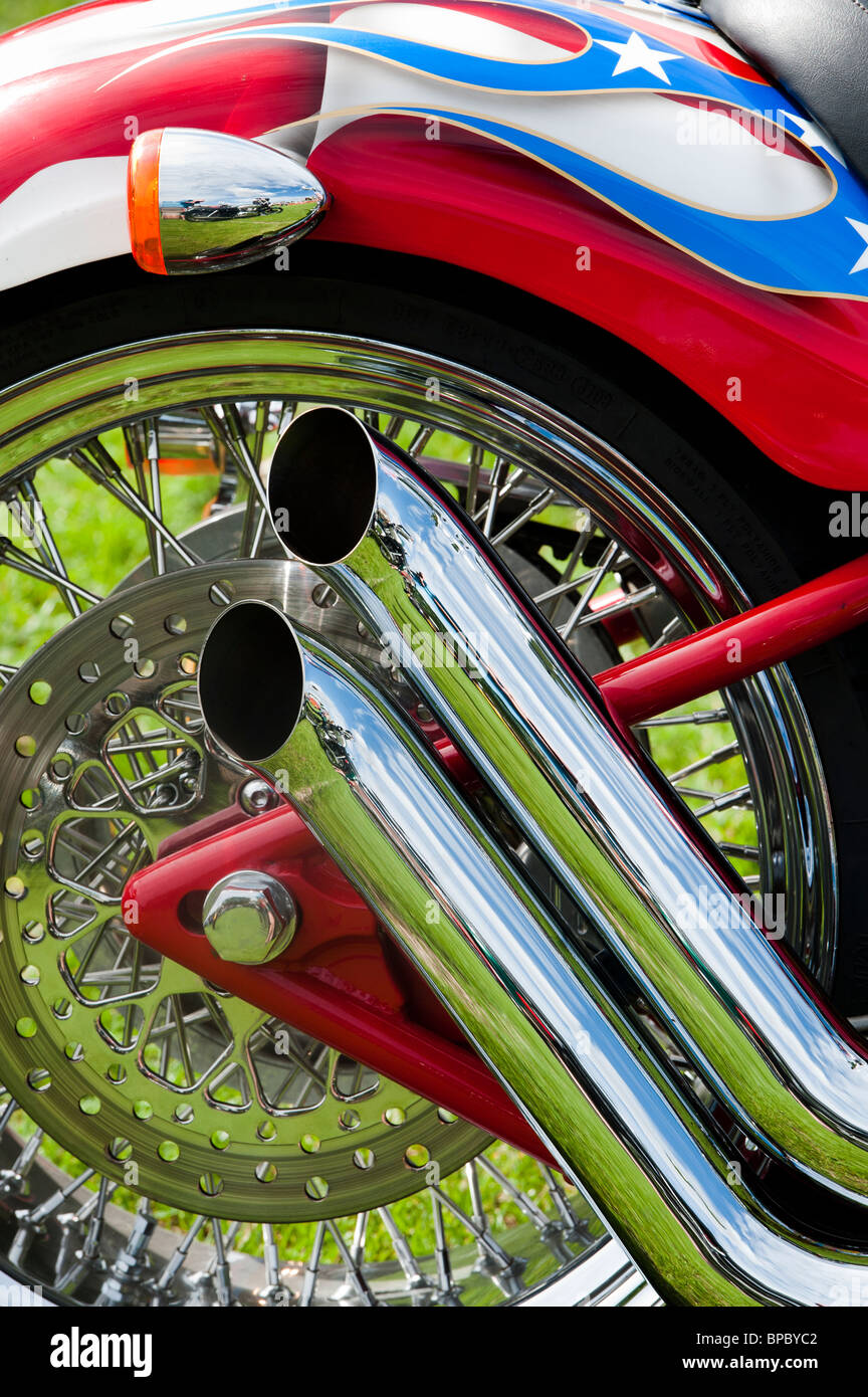 wheelHarley Davidson motorcycle chrome exhaust pipes, with custom american flag paint work on mudguard Stock Photo