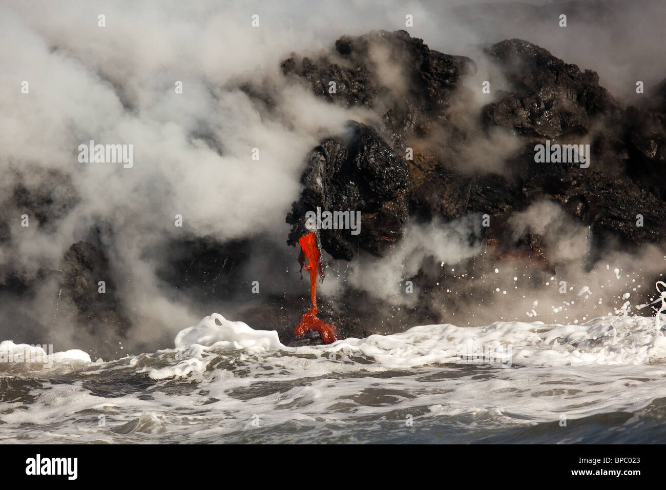 Molten lava flowing into the ocean Stock Photo