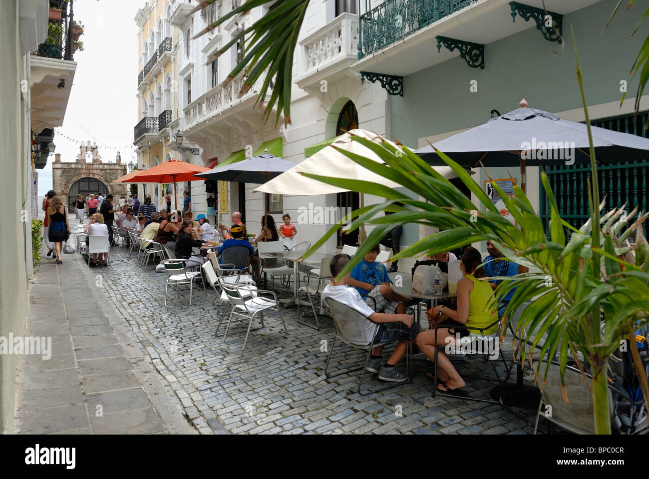 Open air Cafe on Santo Cristo St. with Cristo Chapel in the background, Old San Juan, Puerto Rico Stock Photo