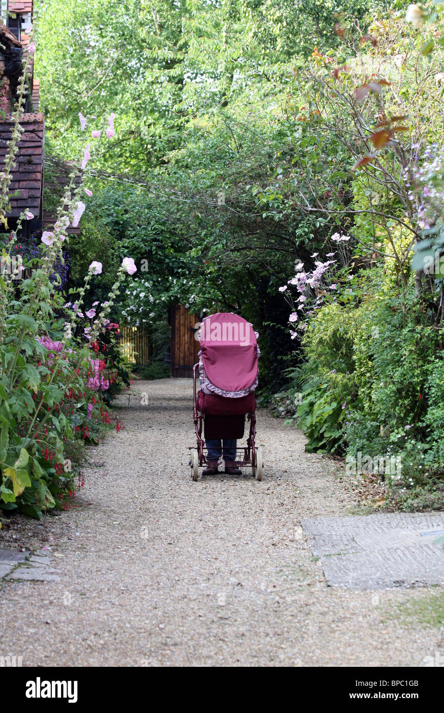Red pram on a path in Streatley Stock Photo