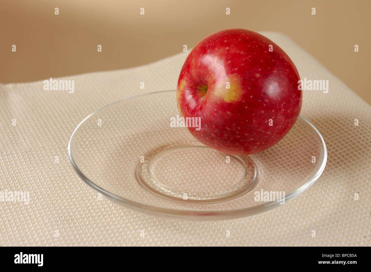 Red apple on plate still life Stock Photo