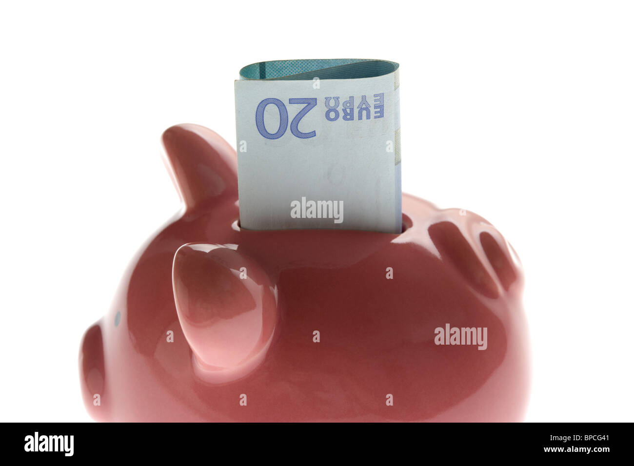pink piggy bank with 20 euro note on white background Stock Photo