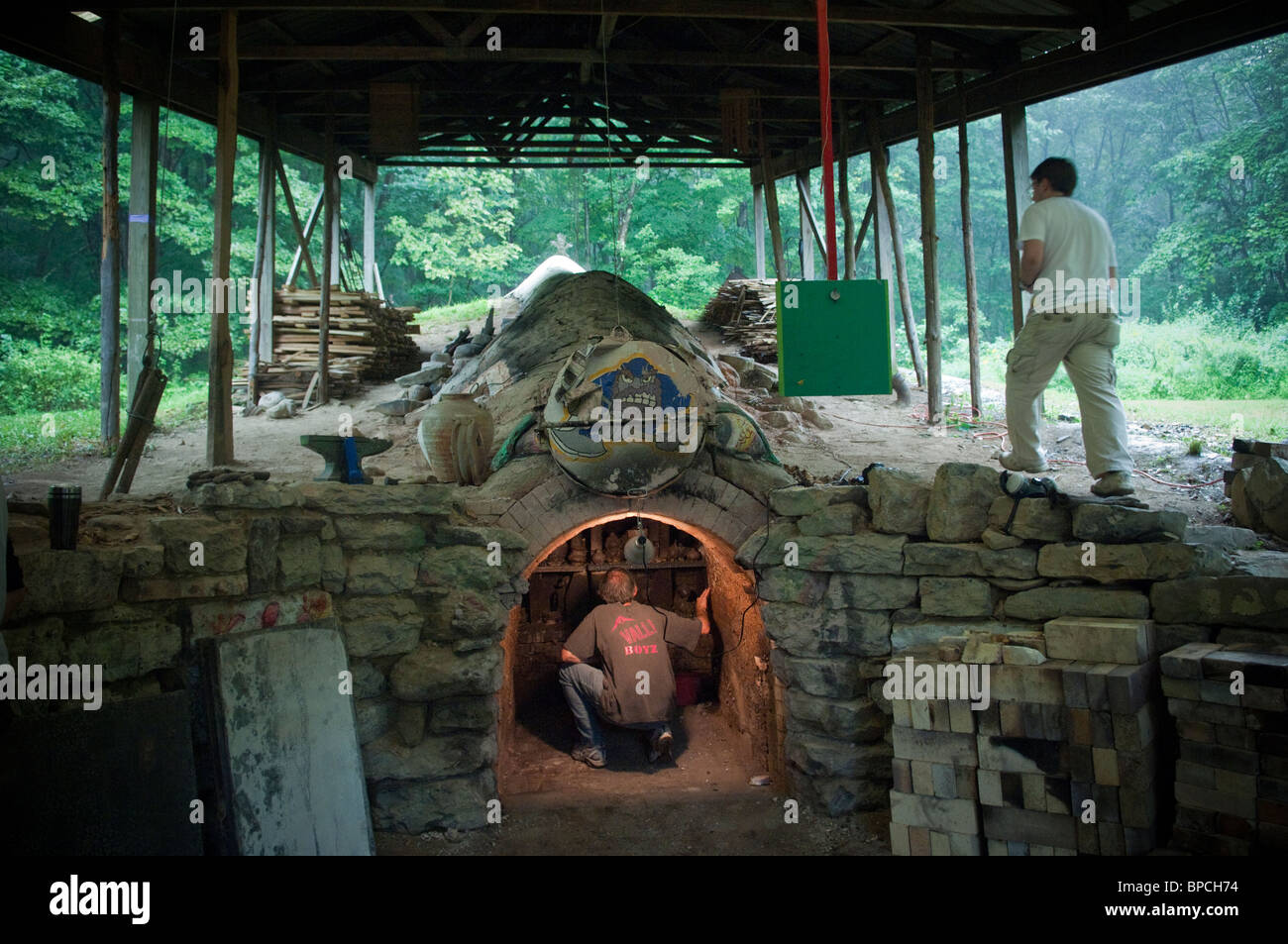 An anagama pottery kiln is emptied after a firing and subsequent cooling down Stock Photo