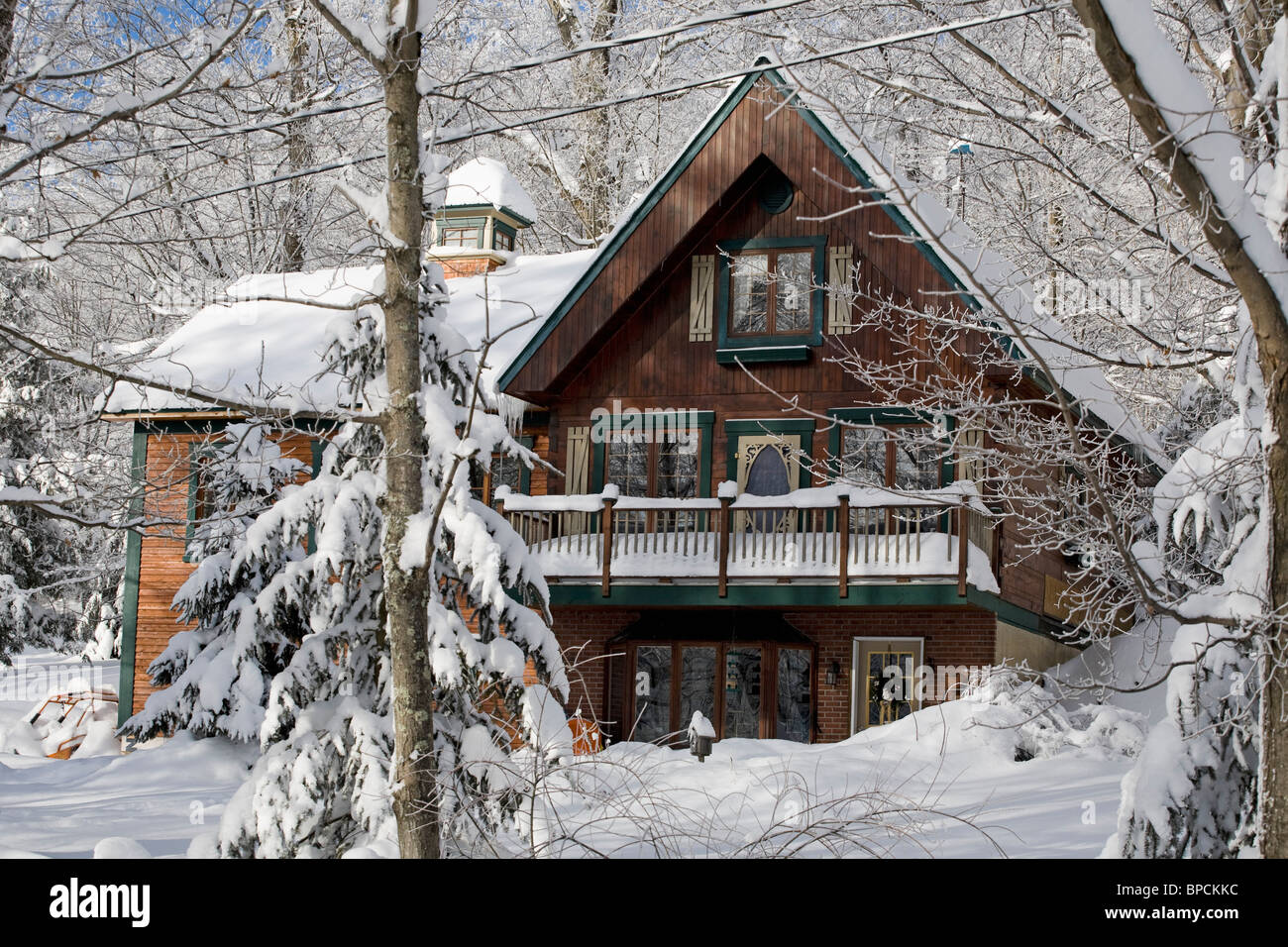 iron hill, quebec, canada; a house covered in snow in winter Stock