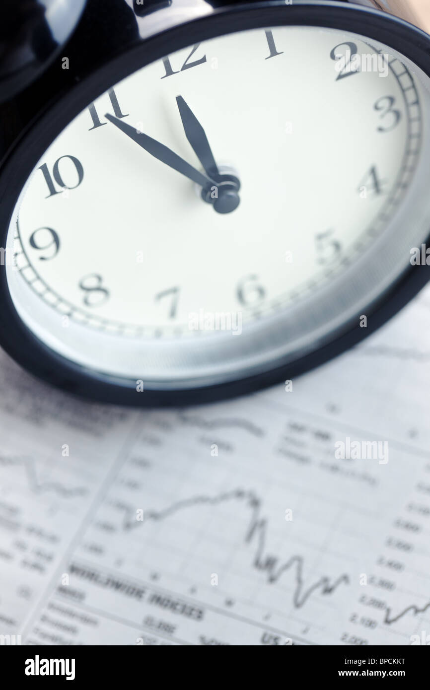 the alarm clock on financial graph.last moment Stock Photo