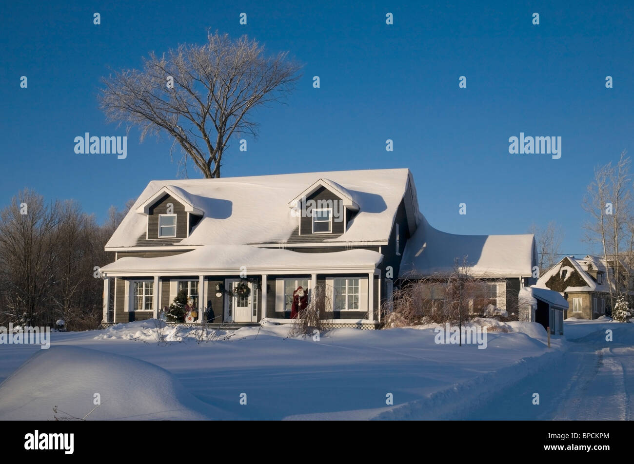 shefford, quebec, canada; a house covered in snow in winter Stock Photo