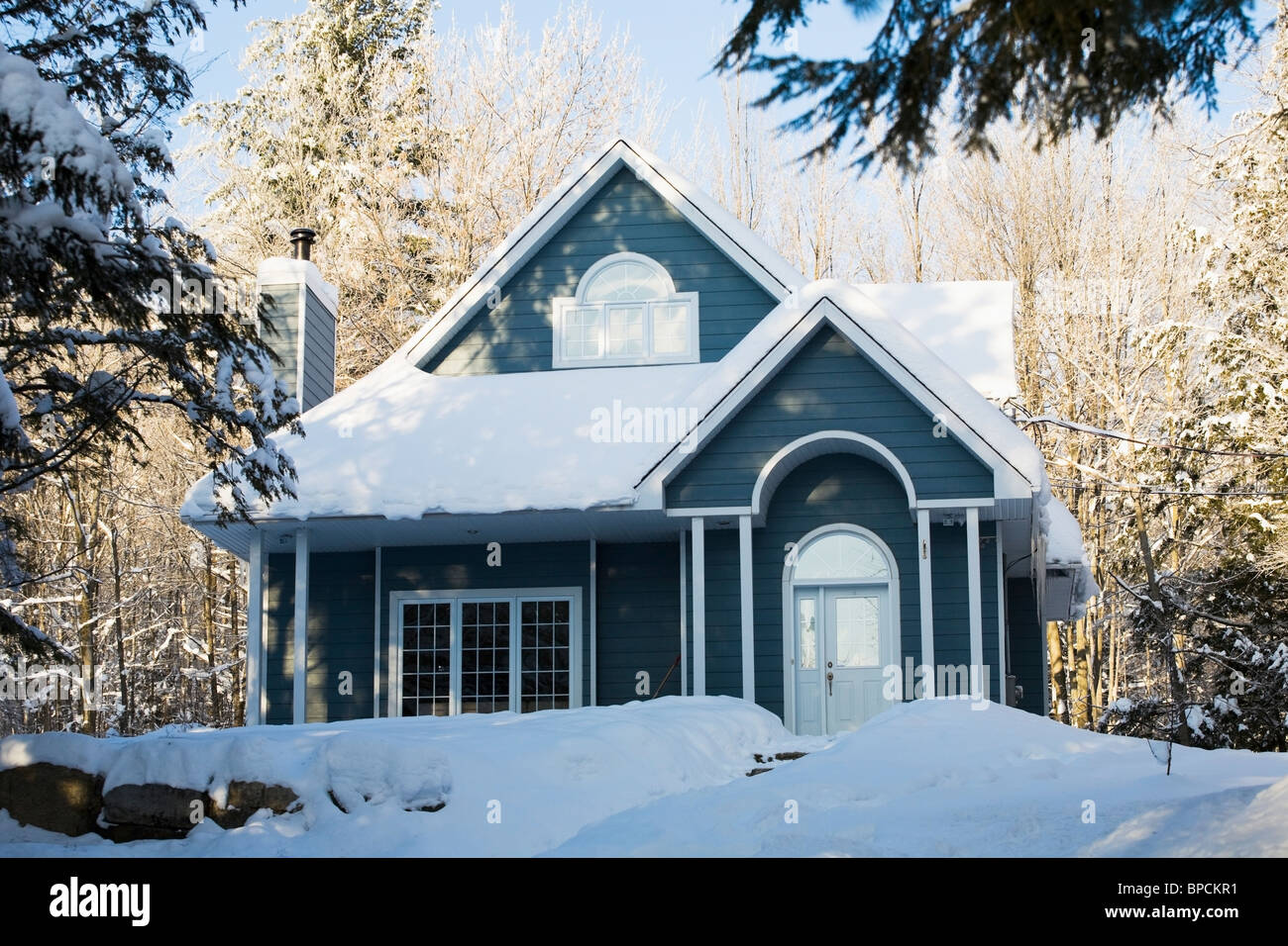 shefford, quebec, canada; a house covered in snow in winter Stock Photo