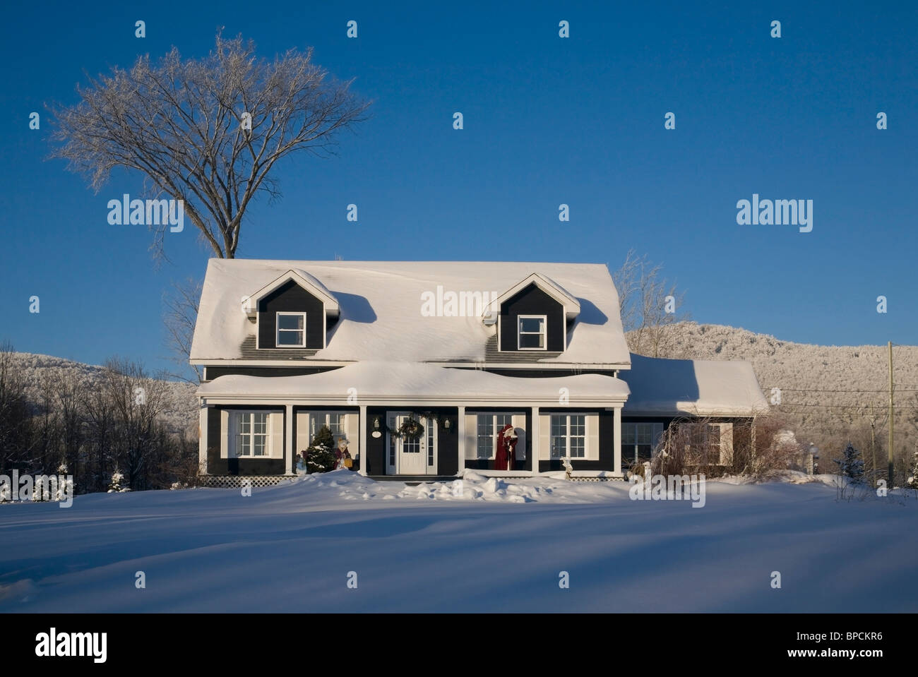 shefford, quebec, canada; a house covered in snow in winter Stock Photo