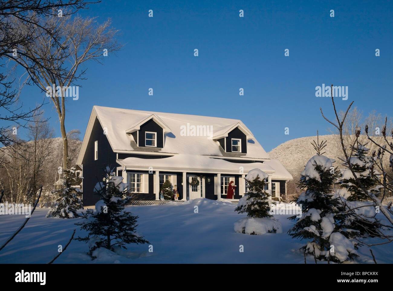 shefford, quebec, canada; a house covered in snow in winter Stock Photo