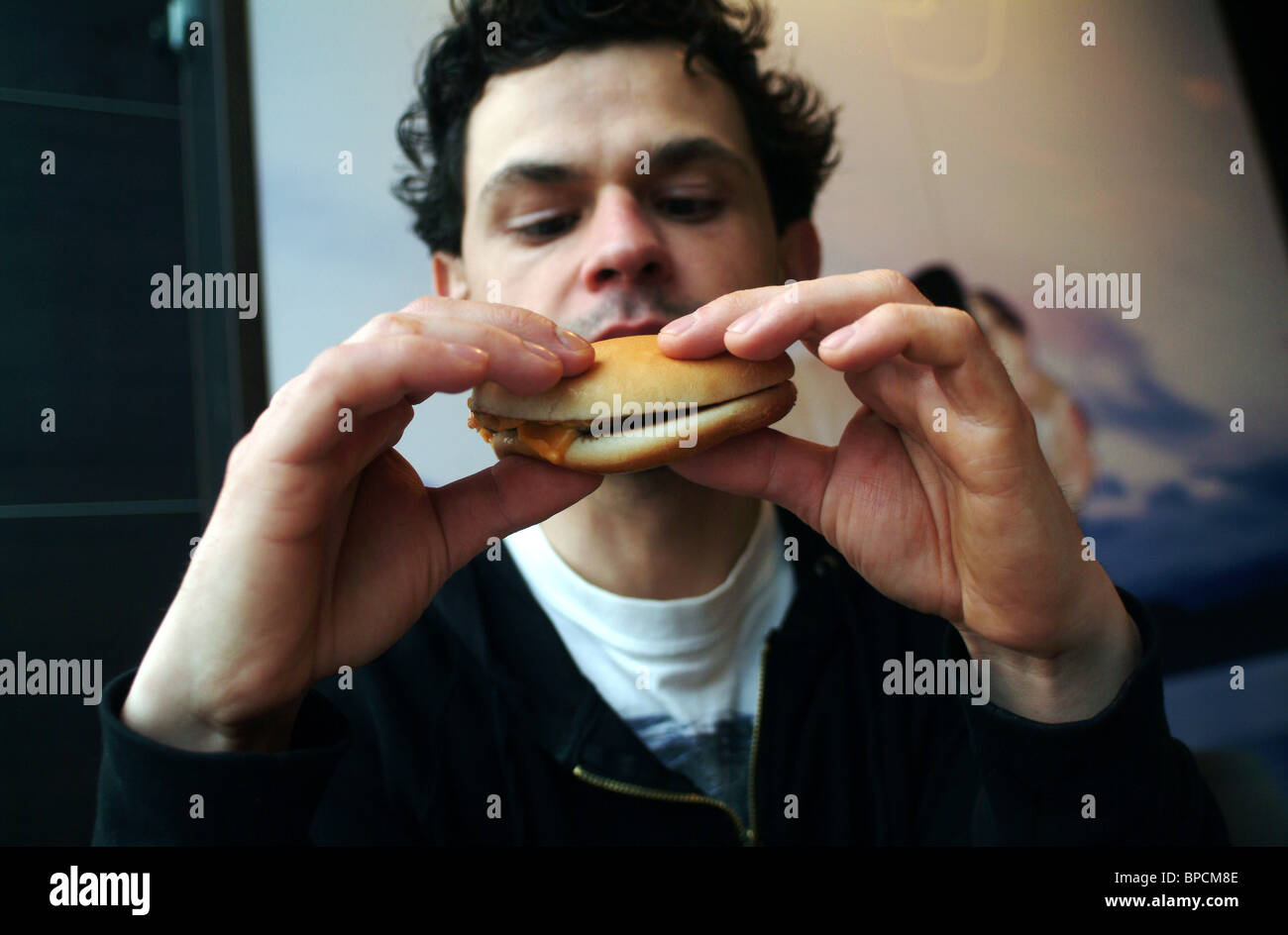 A man eating at McDonald's Stock Photo Alamy