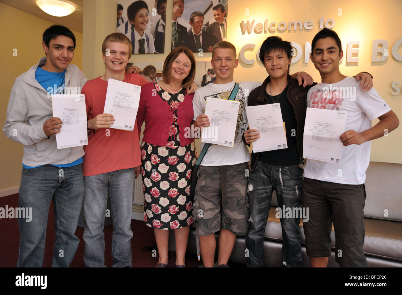 Head Teacher of a boys school posing with her successful teenage boy