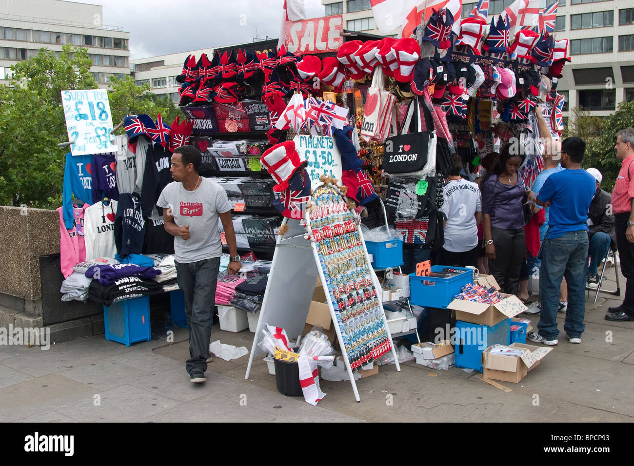 tourist gift stall looking London hats shop seller Stock Photo