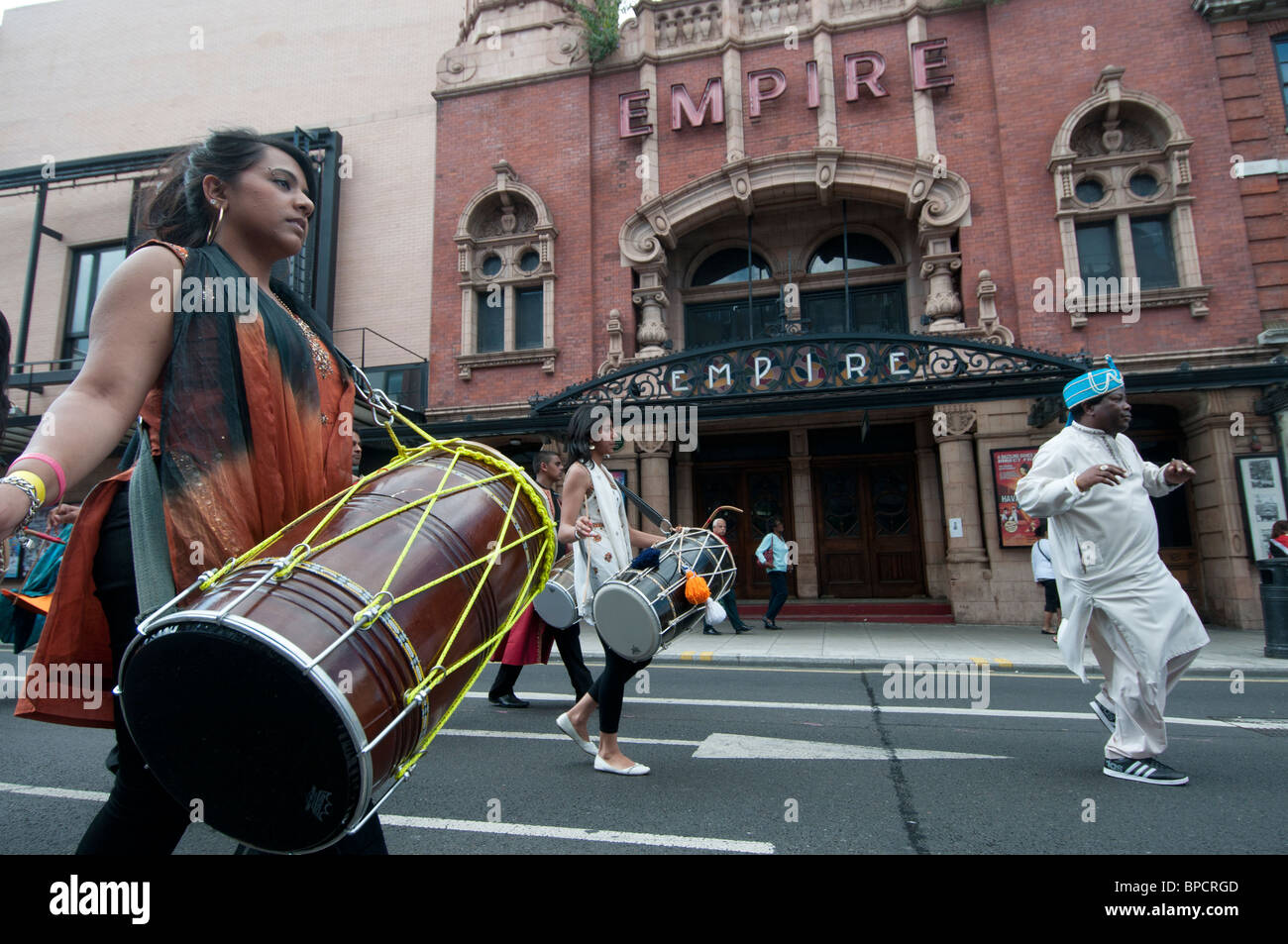 Hackney carnival parade. Young woman with Asian drum Stock Photo